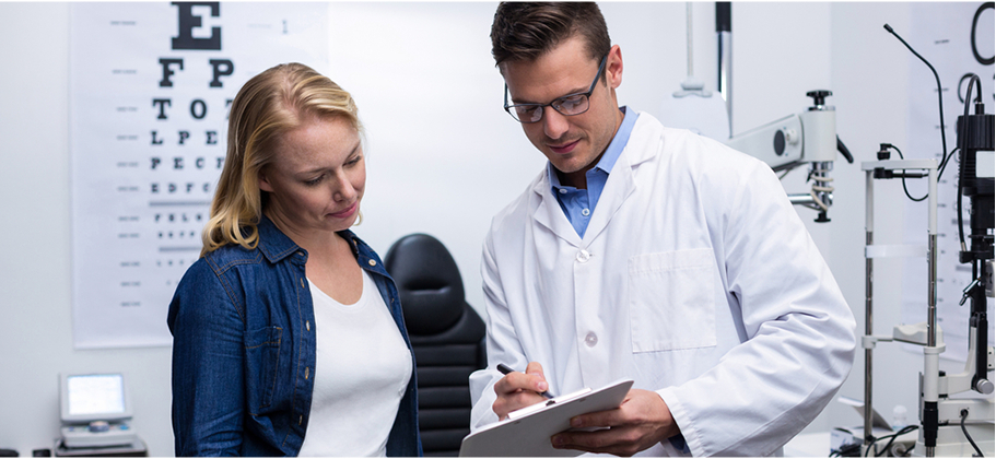 Eye Doctor Going Over Eye Exam Results With Patient