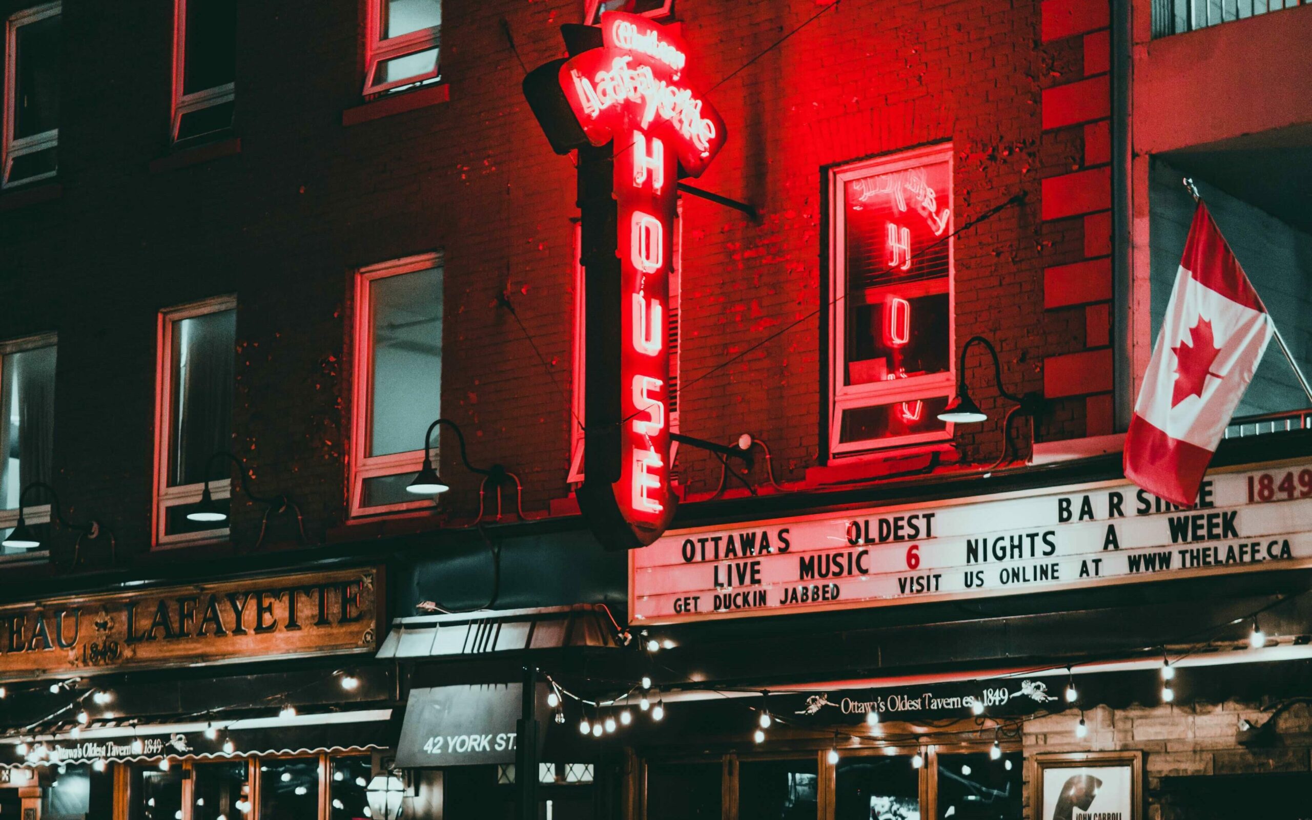 The illuminated storefronts of ByWard Market in downtown Ottawa